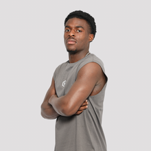 Load image into Gallery viewer, Man wearing a gray sleeveless shirt with a logo on a light gray background