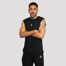 Load image into Gallery viewer, Man wearing a black sleeveless shirt and pants with a logo on a light gray background

